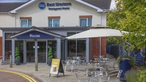 A Best Western hotel with outdoor seating and a 'Welcome' sign. - Best Western Pontypool Metro Hotel (Pontypool)
