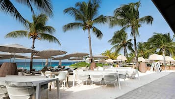 On the beach, white sand, sun-loungers, beach towels