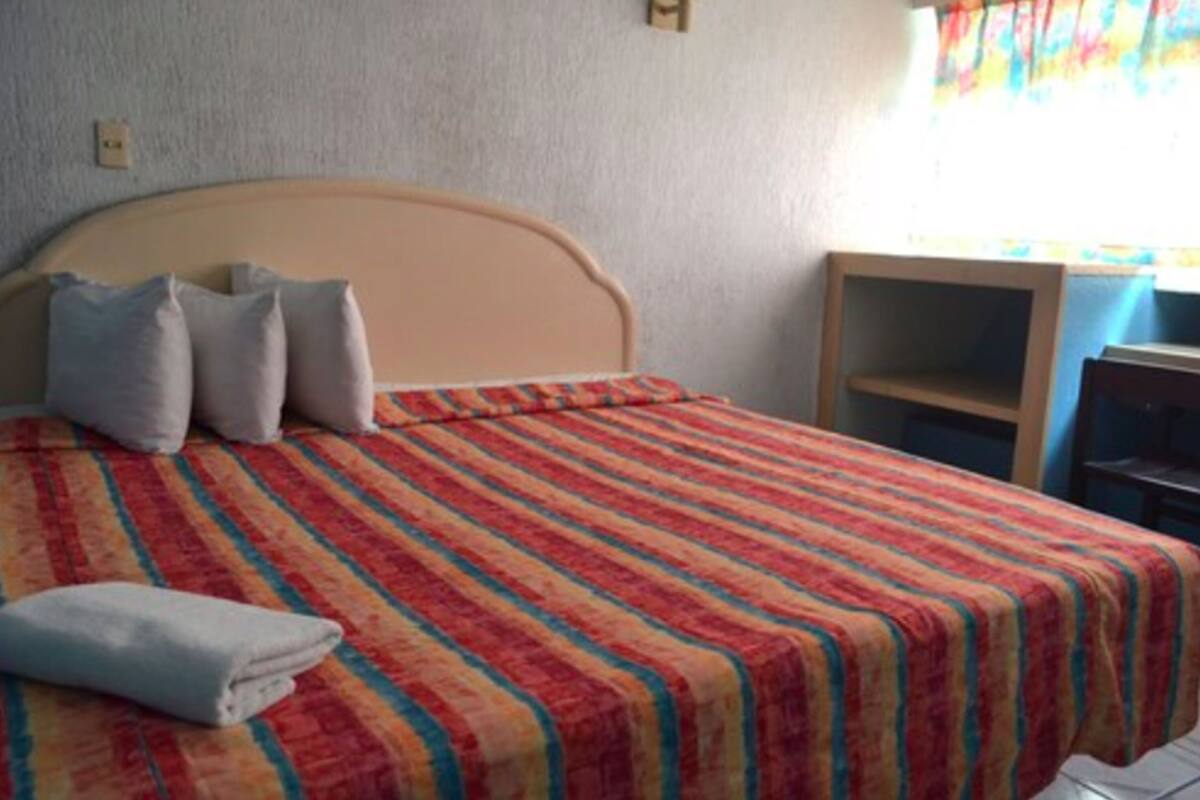 Economy Single Room, 1 King Bed | In-room safe, desk, iron/ironing board (on request), WiFi (free)