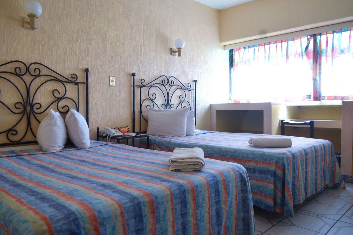 Economy Double Room, 2 Double Beds | In-room safe, desk, iron/ironing board (on request), WiFi (free)
