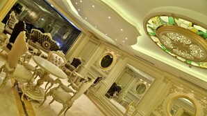 An opulent room with ornate furniture, a chandelier, and a large mirror. - Cassiel Hotel (Ankara)