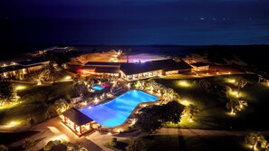 An aerial view of a resort with a swimming pool, multiple buildings, and a beach. - Tio Tom All Inclusive (Punta Ballena)