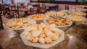 A buffet table with various food items.