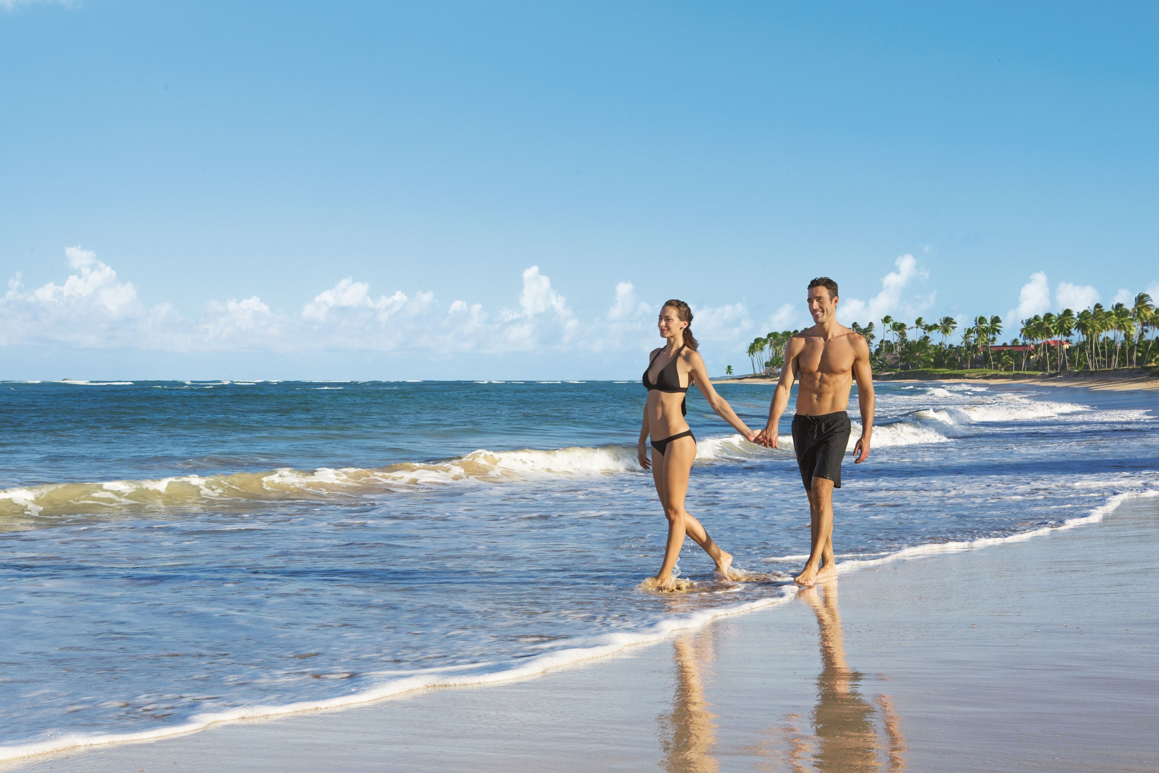 A beach with a clear sky and ocean waves.
