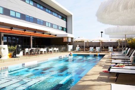 Outdoor pool, pool umbrellas, pool loungers. Atura Blacktown
