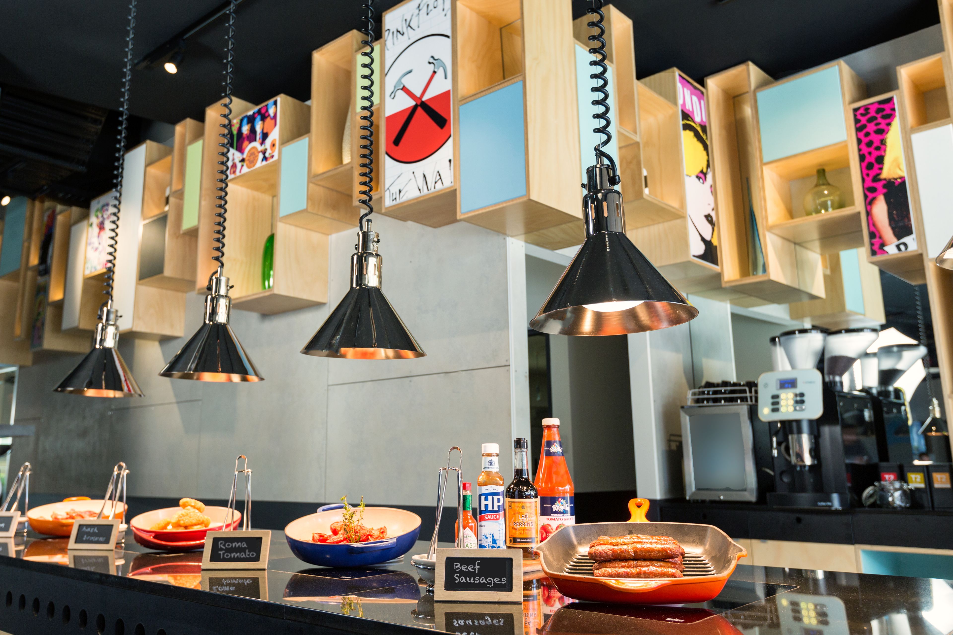 A buffet area with various dishes labeled, including 'Beef Sausages' and 'Roma Tomato'.