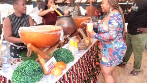 A market stall with large pots, a plastic container, and a sign that reads "ZOOM". - Bojo Beach Resort (Bortianor)