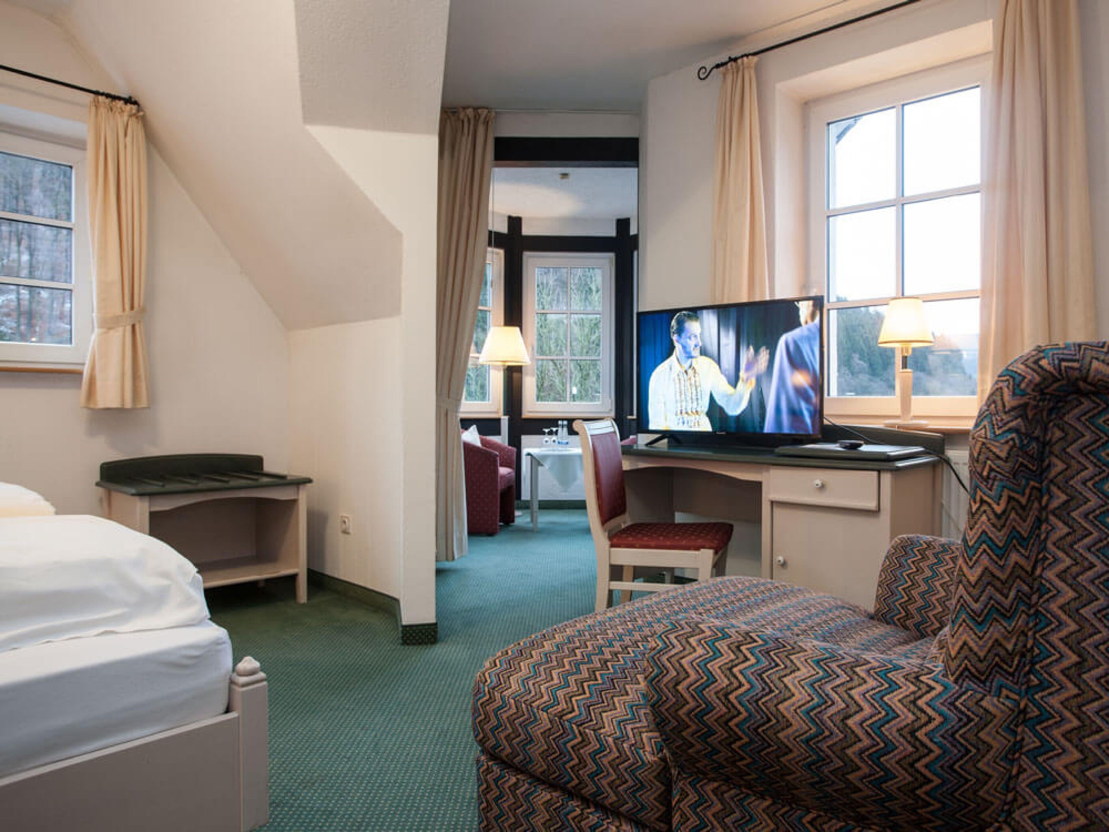 deluxe double room | living area | 120-cm smart tv with satellite channels, tv, netflix