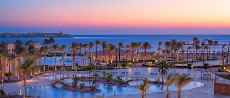 7 outdoor pools, open 7:00 AM to 5:00 PM, pool umbrellas, pool loungers