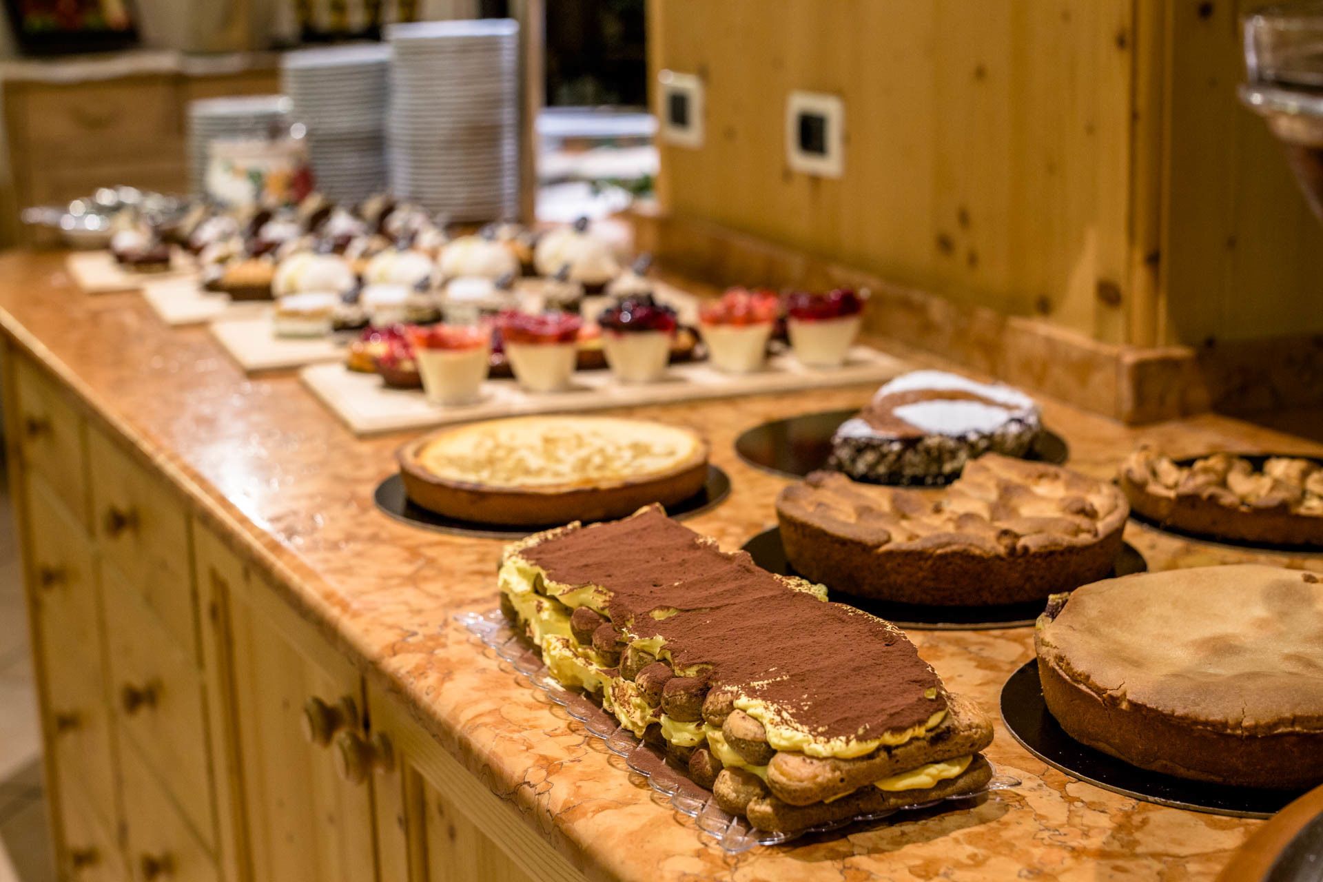 A buffet with various desserts including cakes and pastries.