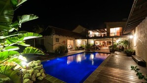 A two-story house with a swimming pool, surrounded by tropical plants and a wooden deck. - Gecko Ridge Guest House (Swakopmund)