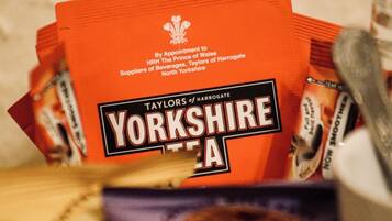 Een stapel rode pakjes met de tekst 'Yorkshire Tea' en een doos 'Border' koekjes.