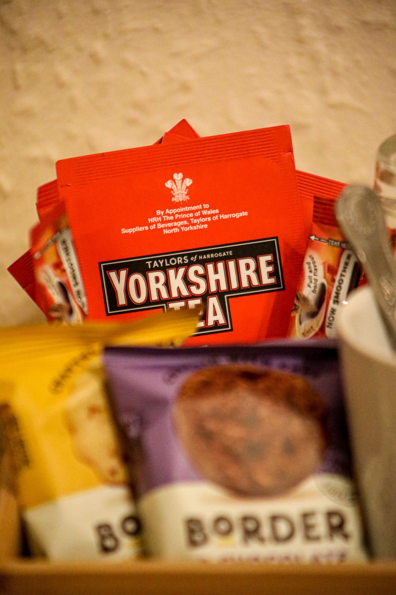 A collection of Yorkshire Tea packets and a packet of Border biscuits.