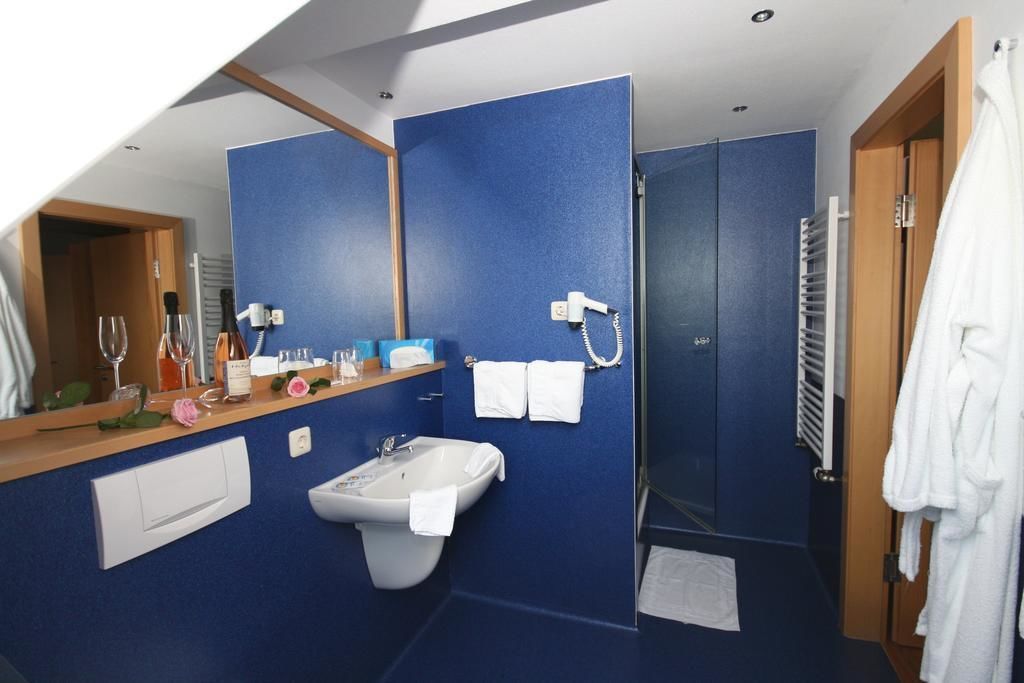 shower, hair dryer, slippers, towels