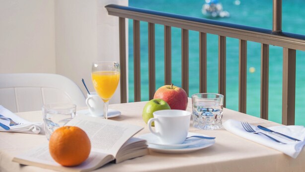 A table set for breakfast with a view of the ocean. - Bahia (Santa Eulalia del Rio)