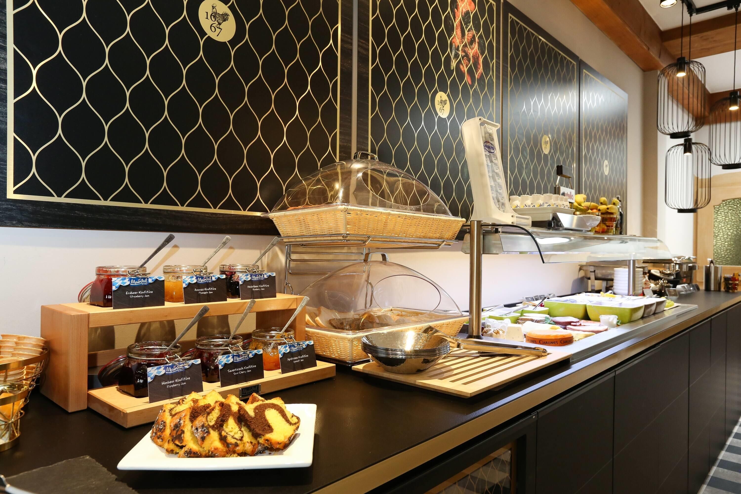 A buffet area with various food items and condiments.