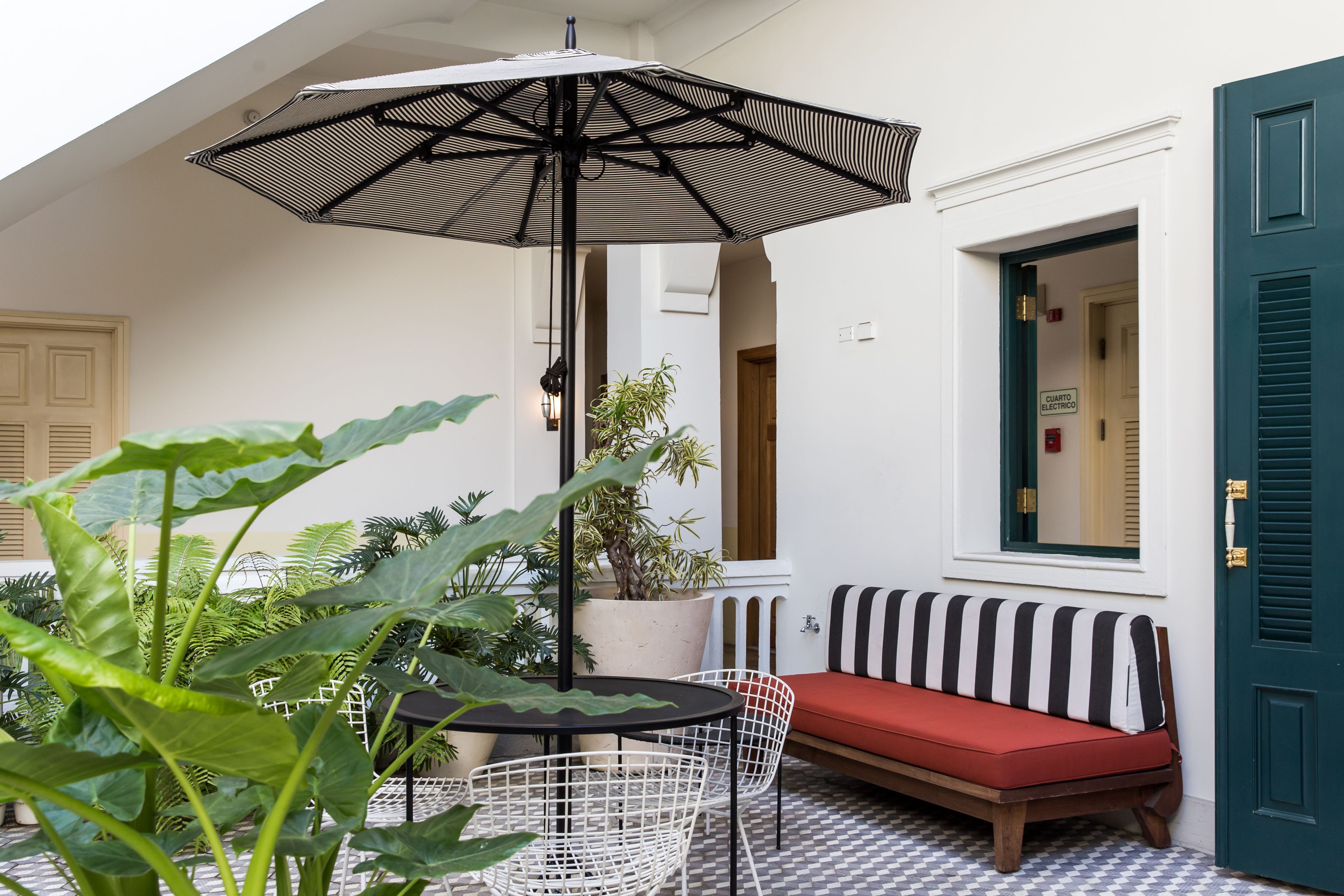 A cozy outdoor seating area with a table, chairs, and a large umbrella.
