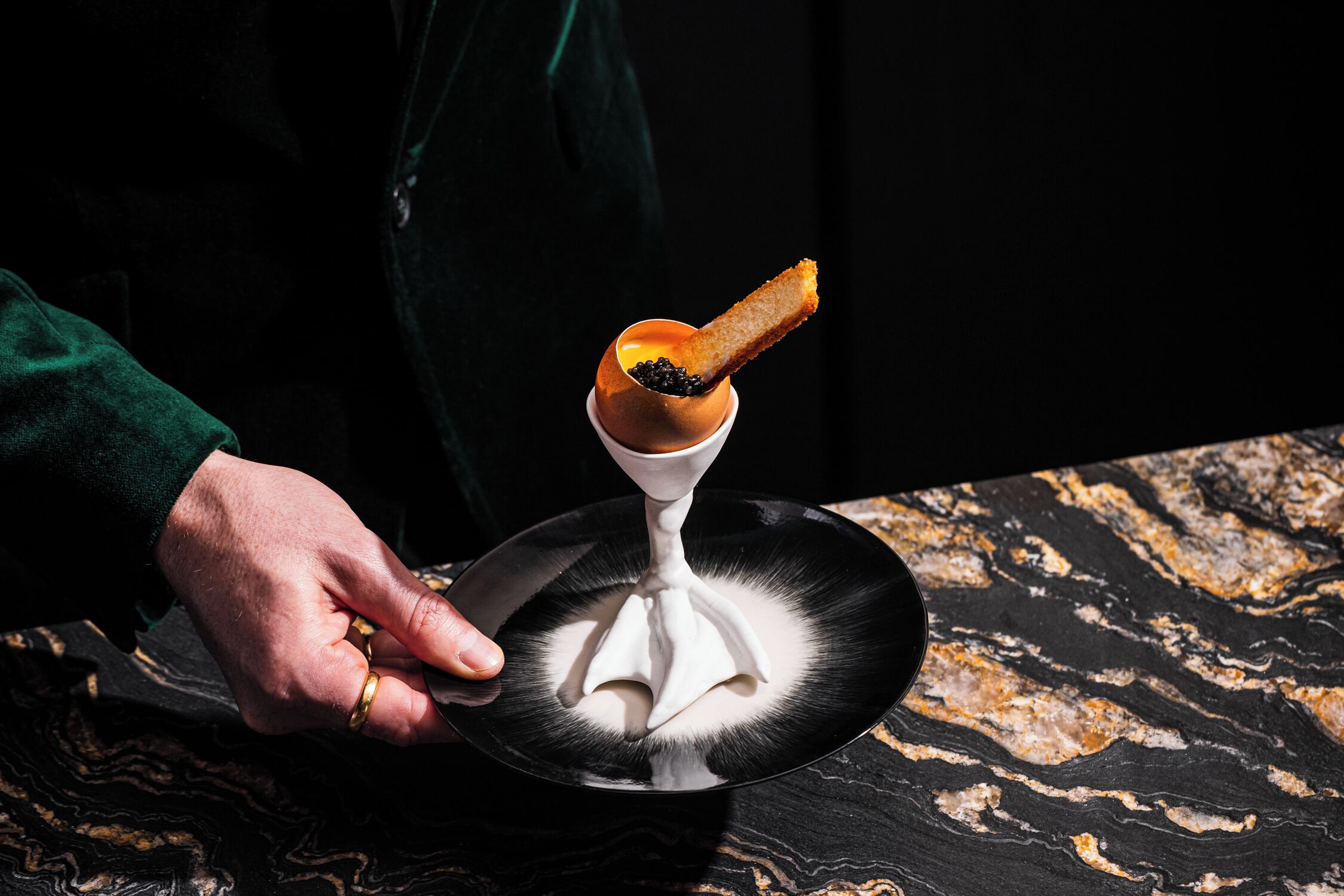 A person holding a plate with a dessert.