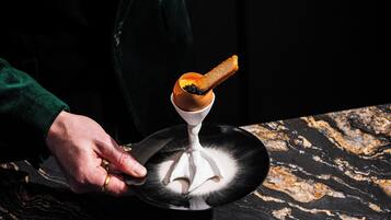A person holding a plate with a dessert.