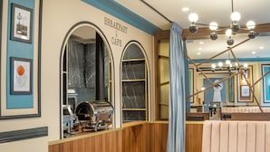 A breakfast and cafe area with a wooden counter, espresso machine, and seating. - Hotel Boronali Montmartre (Paris)