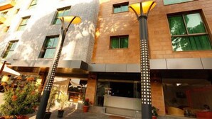 A hotel with a modern facade, multiple windows, and outdoor lighting fixtures. - Hotel Le Noble (Zouk El Kharab)