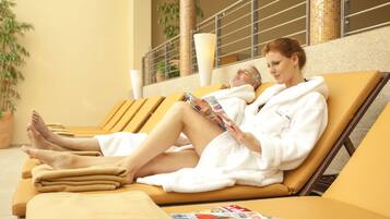 A spa area with reclining chairs, a magazine, and a towel.