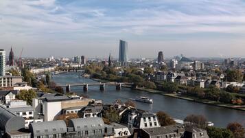A river with a bridge, buildings, and a modern skyscraper.