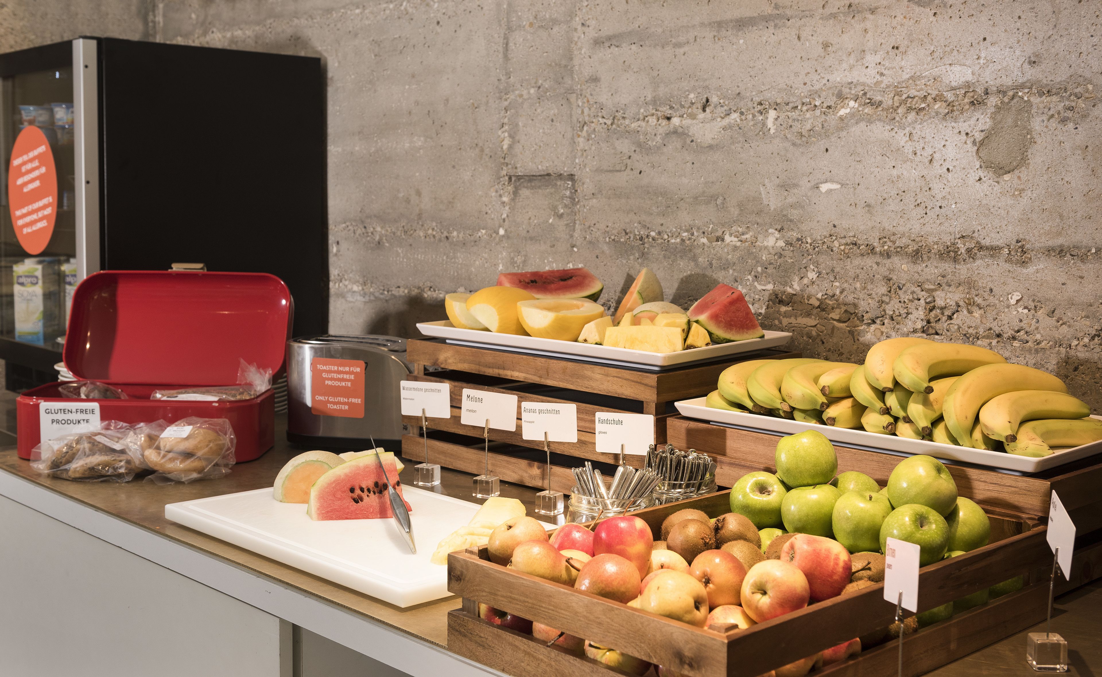 A variety of fruits and gluten-free products on display in a store.