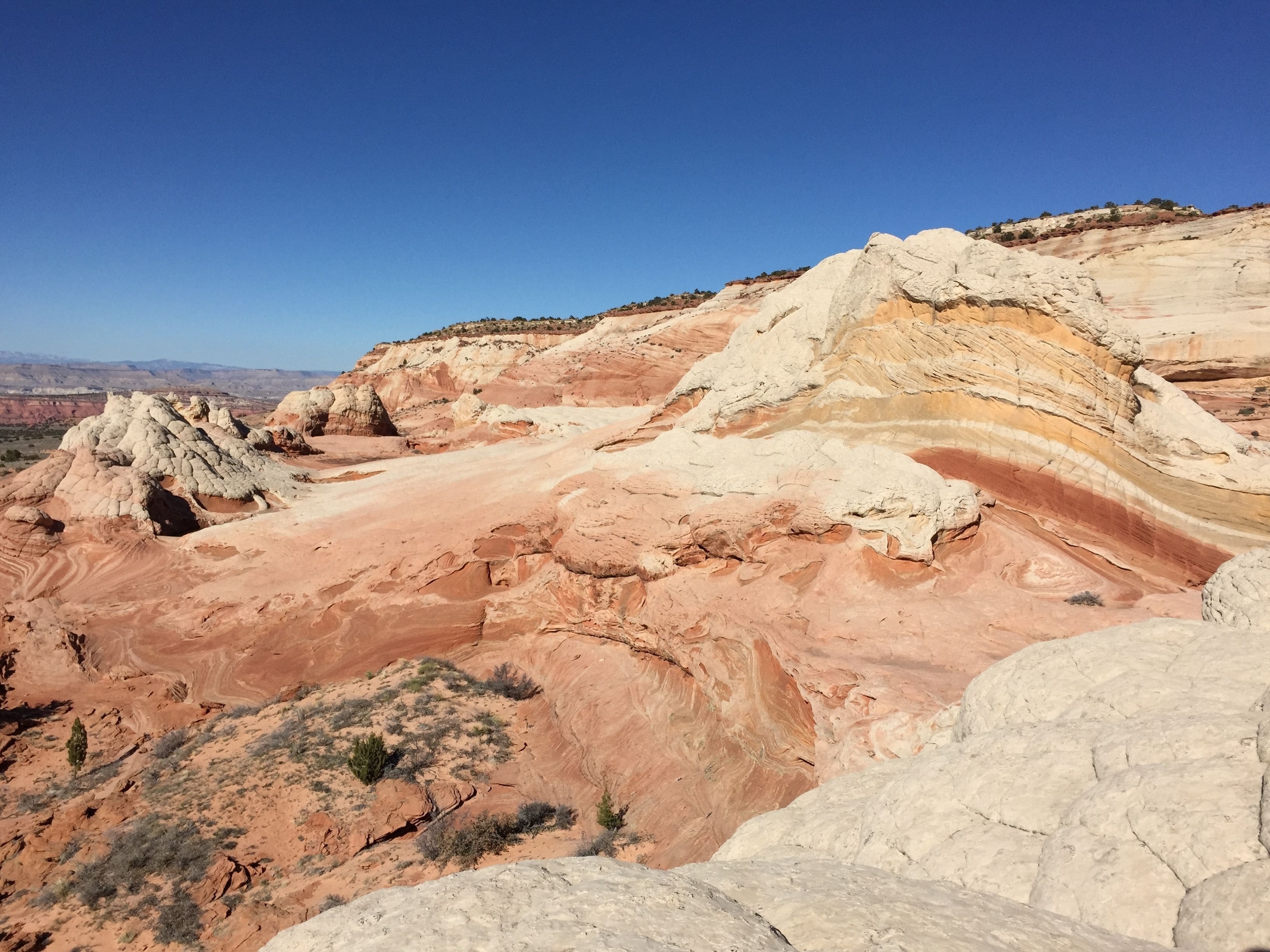 A rugged landscape with layered rock formations and sparse vegetation.