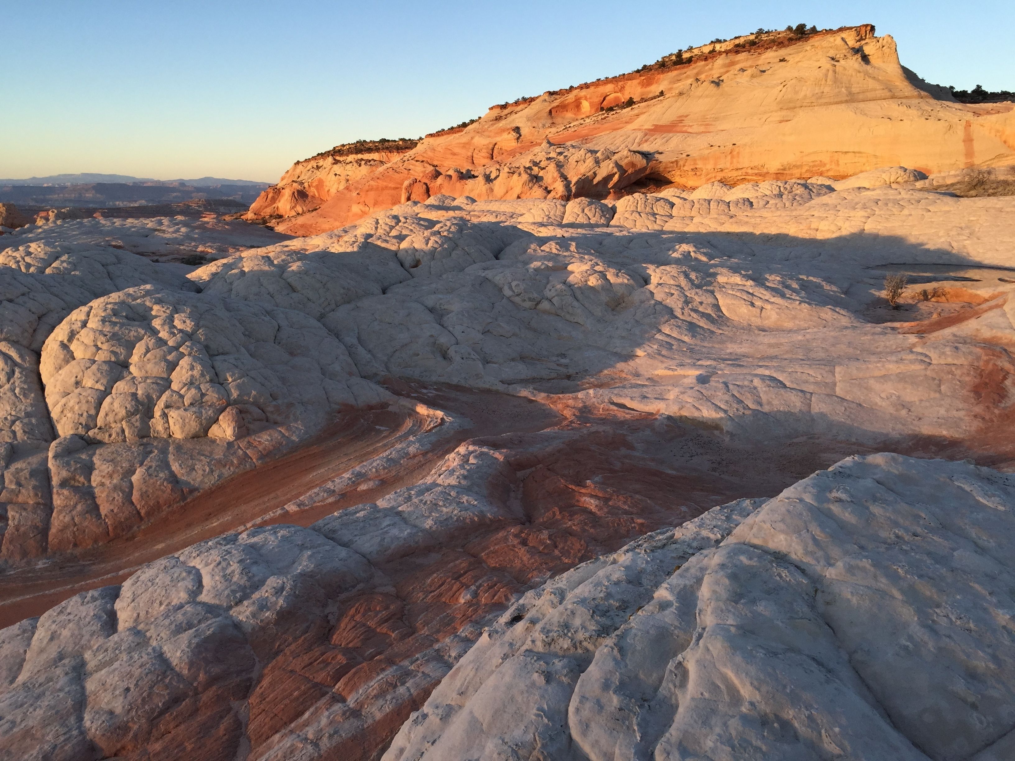A rugged, rocky landscape with a prominent hill and a winding path.