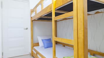 A bunk bed with a white door and a blue pillow.