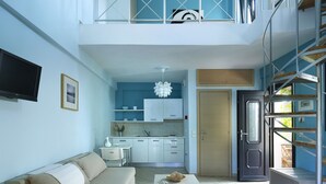 A modern apartment with a living room, kitchenette, and a balcony. - Aeolis Apartments & Studios (Lesvos)
