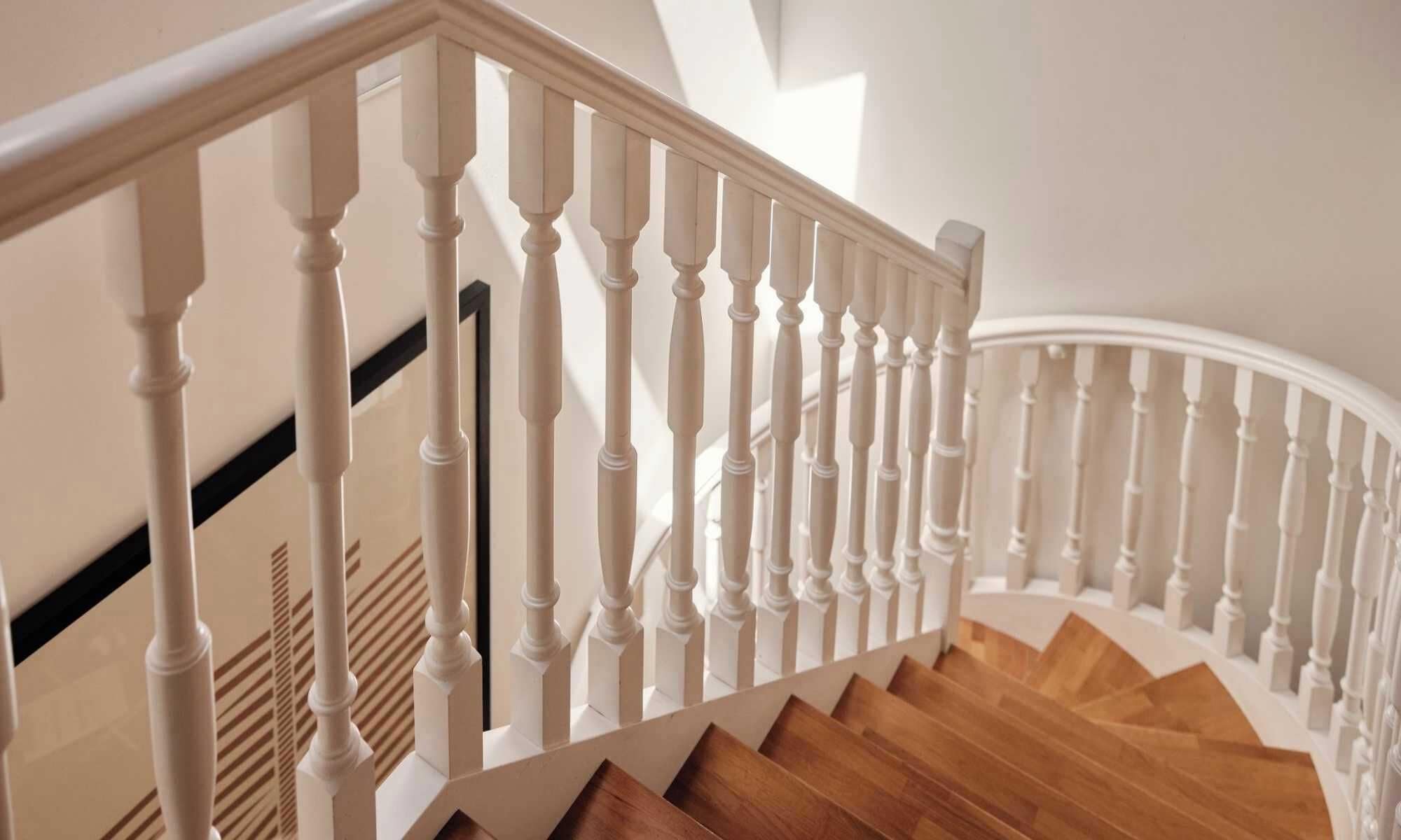 A staircase with white balusters and wooden steps.