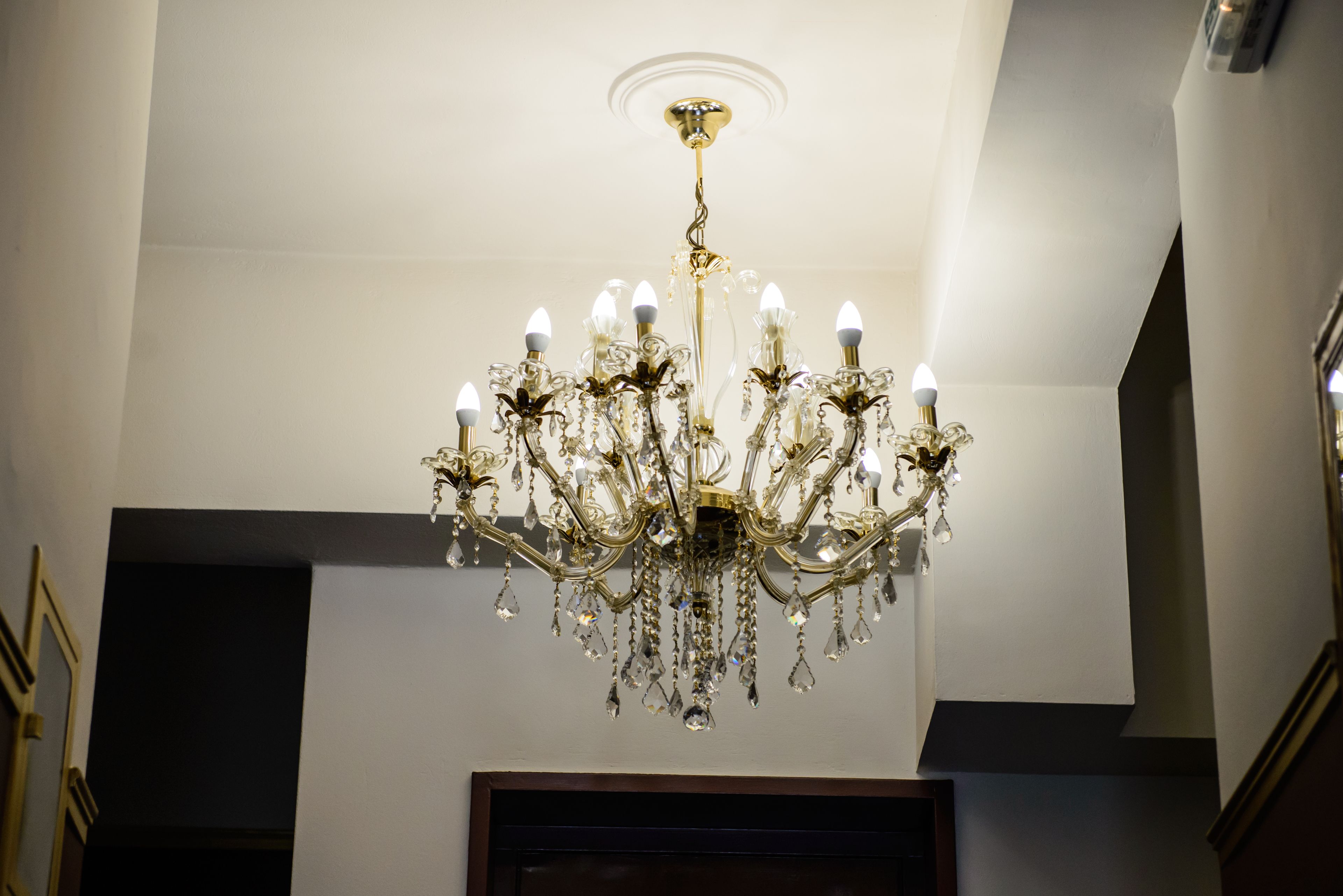 A chandelier with multiple arms and crystal decorations.