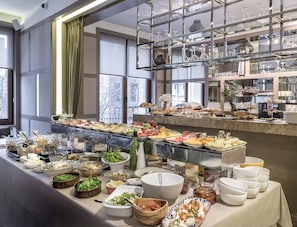 A buffet with a variety of food items and glassware. - The Stay Nisantasi  (Istanbul)