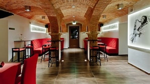 A restaurant with red seating, brick ceiling, and artwork on the walls. - Cottonina Hotel & Mineral SPA Resort (Swieradow-Zdroj)
