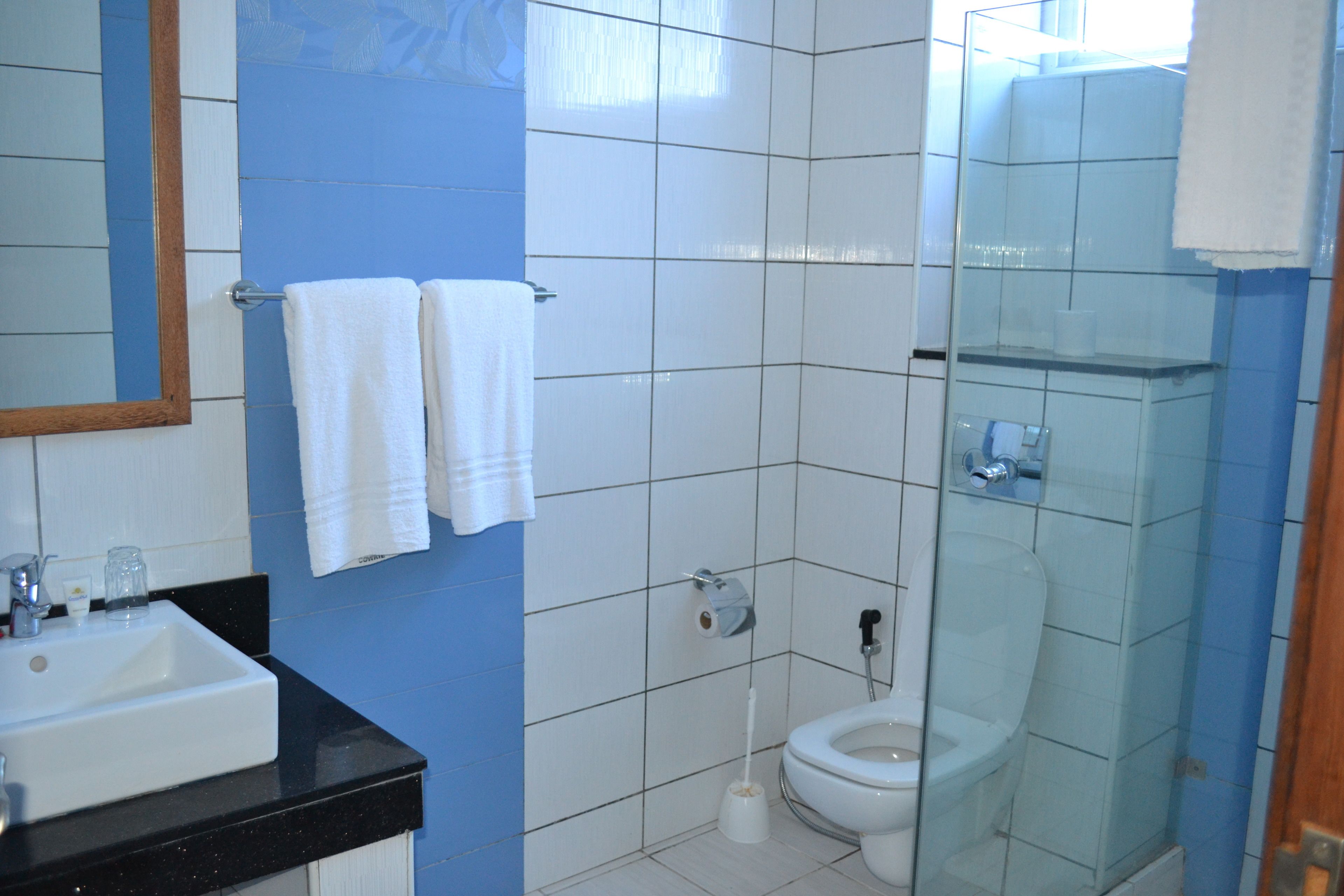 A bathroom with a sink, toilet, and shower.