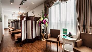 Relax in a serene space with a sofa, armchairs, and a decorative table.