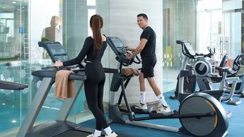 A gym with treadmills and exercise equipment.