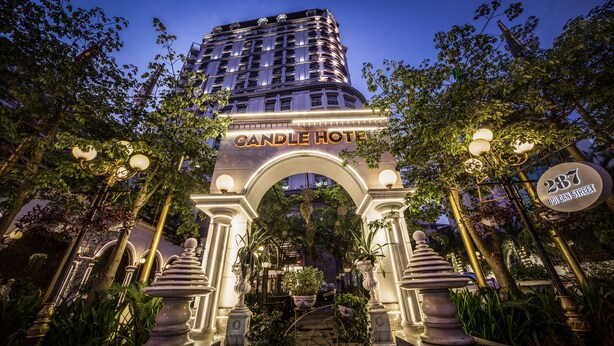 The entrance to Candle Hotel with an ornate archway, a sign indicating the address, and a well-lit facade. - Super Candle Hotel (Hanoi)