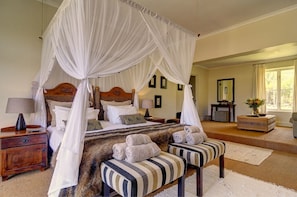 Relax in comfort with a four-poster canopy bed and thoughtful touches.