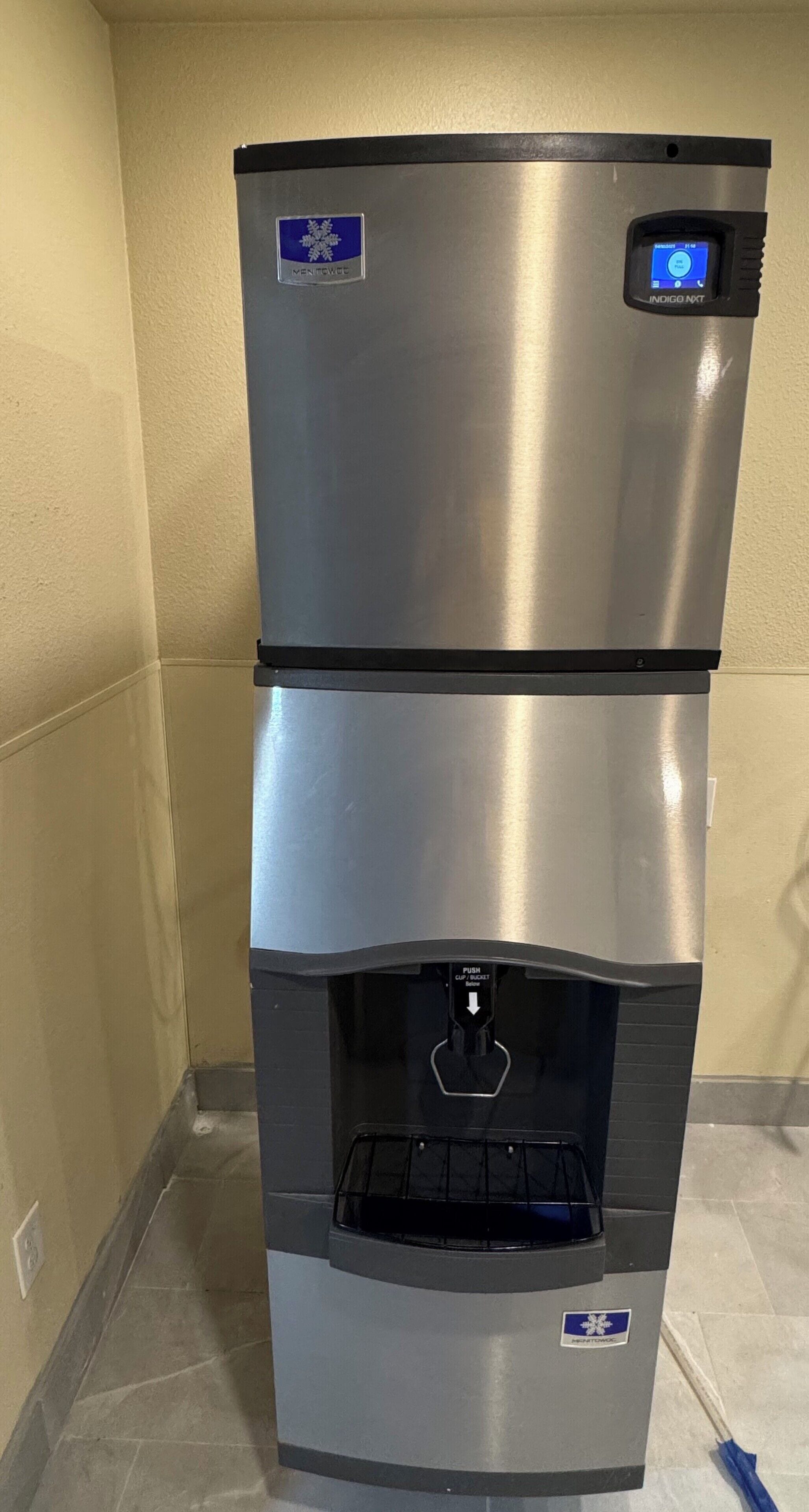 A stainless steel refrigerator with a digital display and a water dispenser.