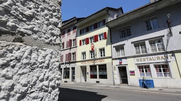 Hotel Roter Ochsen features a traditional European entrance with a red awning and signboard.