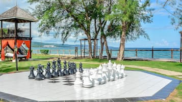 Escape to a serene oasis surrounded by lush greenery and a tranquil body of water, perfect for relaxation and leisurely activities.