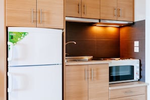 Family Apartment, Partial Lake View | Private kitchen | Fridge, oven, stovetop, highchair - Hotel Apanema Vivari (Nafplio)