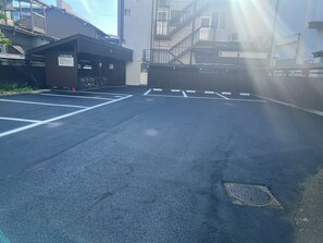 A parking lot with marked spaces and a gated entrance.