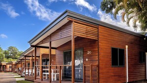 A modern wooden building with a covered porch and a car parked outside. - BIG4 Whitsunday Islands Holiday Park (Flametree)
