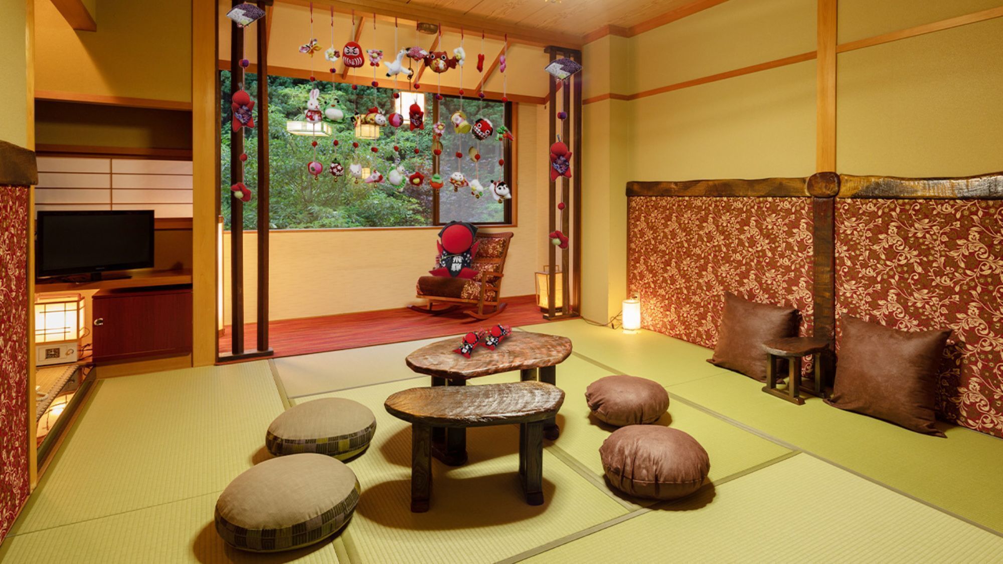 A traditional Japanese room with tatami flooring, a television, a rocking chair, and a decorative wall with hanging ornaments.