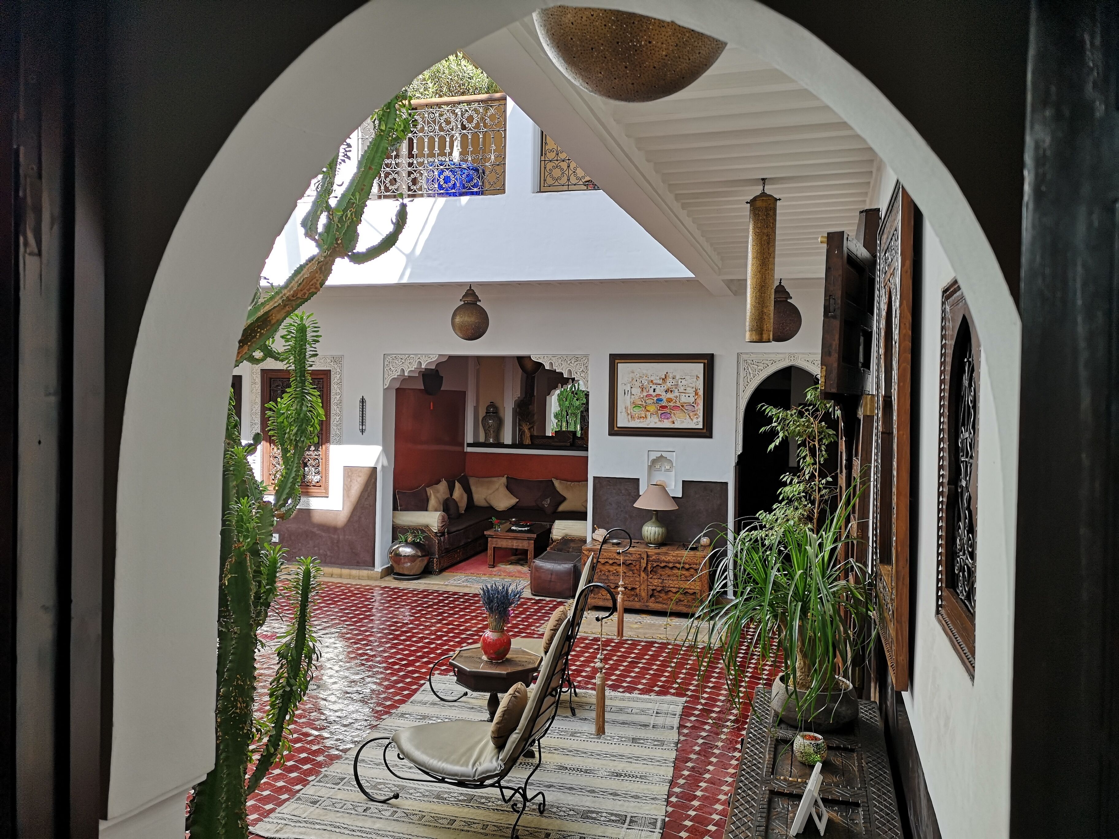 An arched doorway leading to a living area with a sofa, a coffee table, and a chair.