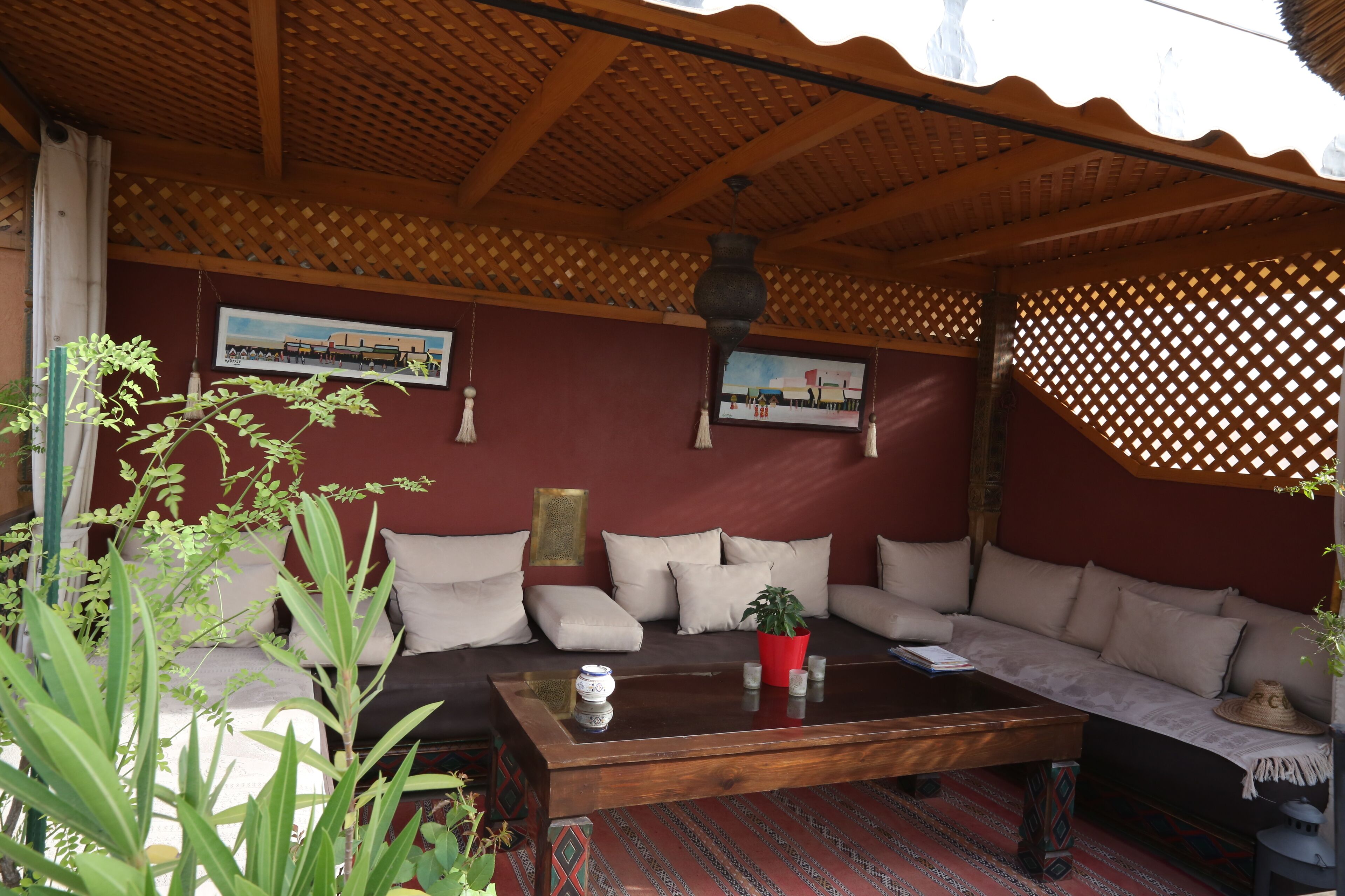 A cozy living area with a wooden ceiling, a sofa set, a coffee table, and a patterned rug.